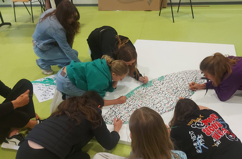 Atelier de calligraphie avec des collégiens.